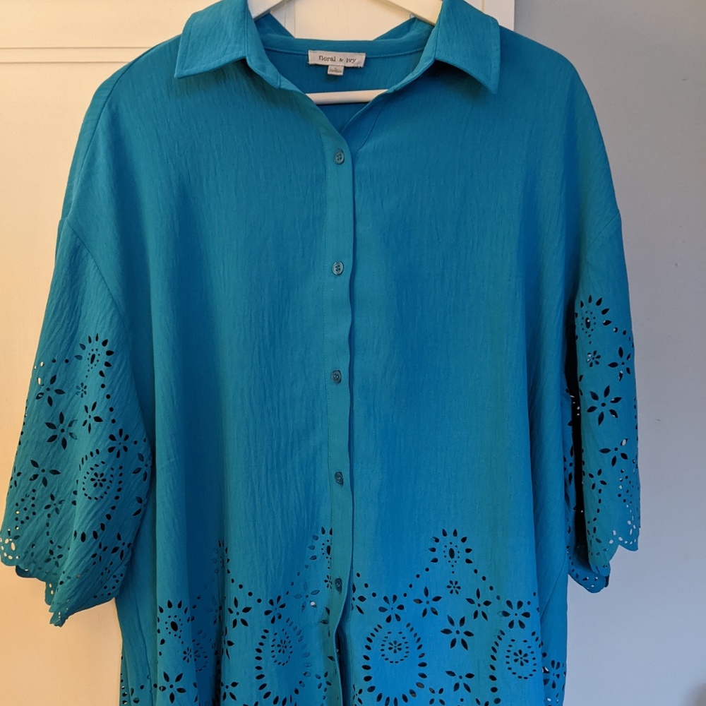 Button down blue blouse with cut outs at sleeves and bottom of blouse
